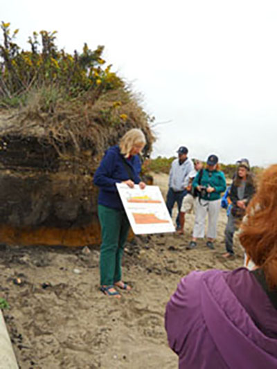 Janet Freedman, coastal geologist for the CRMC, and Michelle Carnevale, project manager for URI’s Coastal Resources Center, speak to a crowd about the effects of erosion and what the CRMC is doing to help the state’s coastal communities plan for the future.