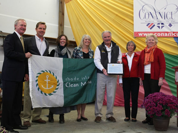 Conanicut Marine Services receives the Clean Marina designation plaque and flag from the CRMC