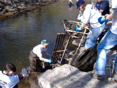 CRMC staff and other volunteers take a swing out of the river