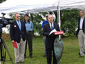 Chairman Michael M. Tikoian speaks to a crowd at the Walker Farm event. At the left is Save The Bay Executive Director Curt Spalding.