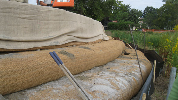 Coir envelopes are stacked on top of each other to create the new profile then material will cover them to create the new slope