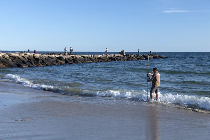 Nathan Vinhateiro of the URI Coastal Institute demonstrates where the mean high tide line was at a public shoreline access event in Westerly in 2022
